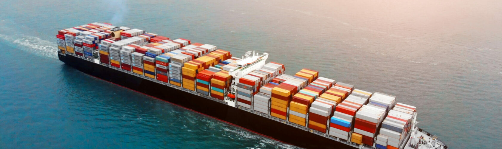 Aerial view of cargo container ship on ocean.